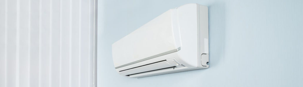 39653653 - young happy woman holding remote control air conditioner in house